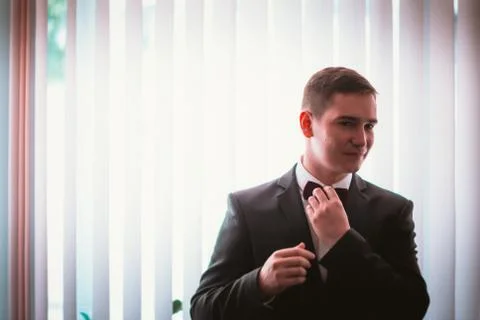 Groom in the background of the window Stock Photos
