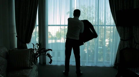 The groom on the background of a window wearing a jacket. Stock Footage 61218658