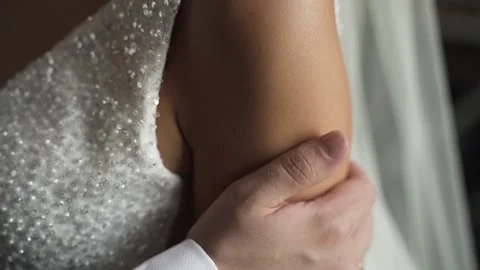 Groom in black jacket gently strokes the bride's hand Stock Footage 170794358