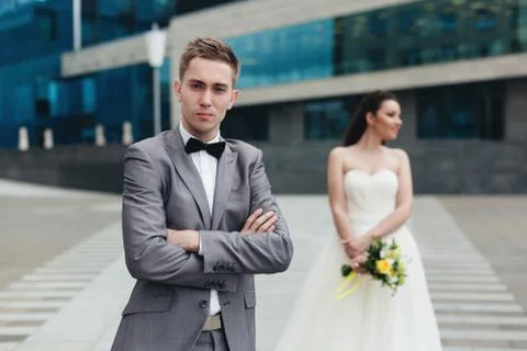 Groom with bride on the background Stock Photos