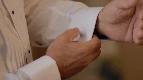 Groom button the cuffs on his white shirt Stock Footage 61182436