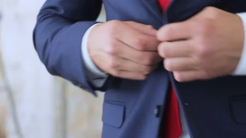 Groom buttoning on his jacket close-up Stock Footage 73290361