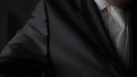 Groom buttons his jacket. Close-up. The preparations of the groom, wedding Stock Footage 73471247
