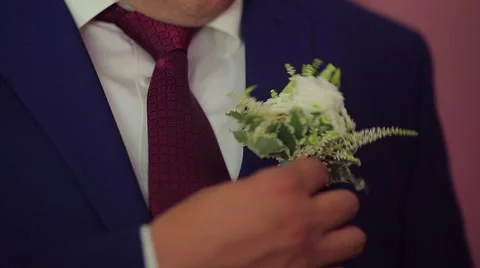 The groom corrects a buttonhole.mp4 Stock Footage 56049753