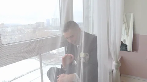 The groom is crying at the window Stock Footage 84564830