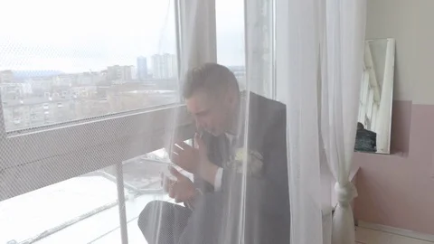 The groom is crying at the window Stock Footage 84565112