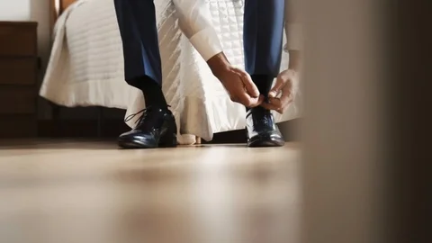 Groom dressing. Fasten the elegant black shoes. Stock Footage 92601413