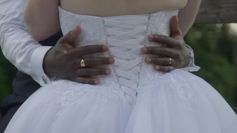 Groom Embraces Bride From Behind With Hands on White Corset Wedding Dress Stock Footage 344439384