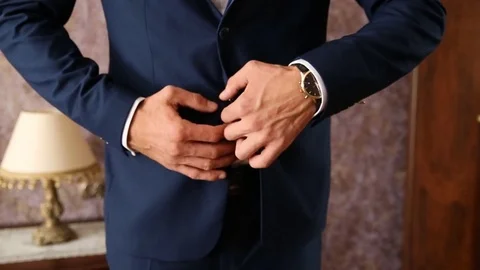 Groom fasten the buttons on his jacket Stock Footage 73104282