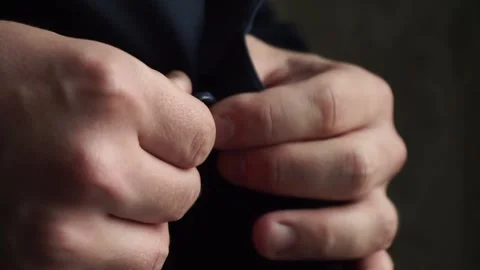 The groom fastens a button on the suit Stock Footage 162035490