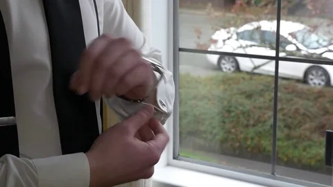 Groom fixing cufflinks, close up on hands. 動画素材 74257552