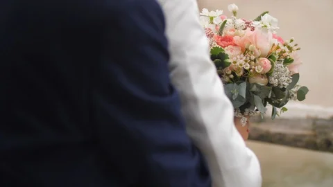Groom gently hugging bride from behind, colorful bouquet in her hands, slowmo Stock Footage 128109021