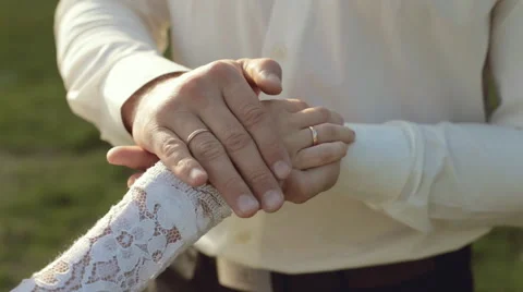 The groom gently stroking hand of the bride Stock Footage 44549695