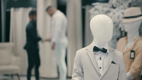 A groom gets organized and dressed for the wedding at a men's clothing store Video stock 225682075