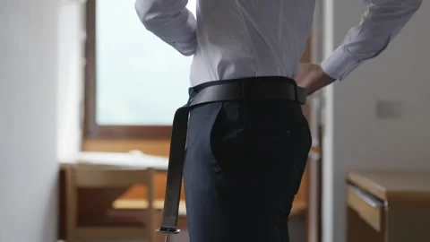 Groom getting dressed before wedding ceremony, fastening belt and preparing Stock Footage 337426256