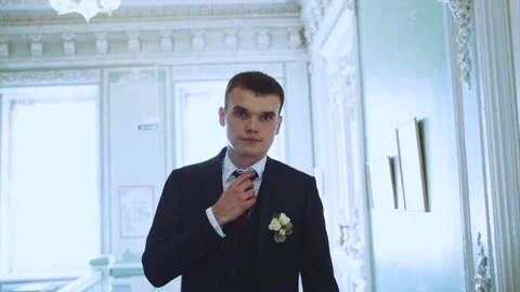 The groom goes to the camera in slow motion, the man's gait in slow motion Stock Footage 229100686