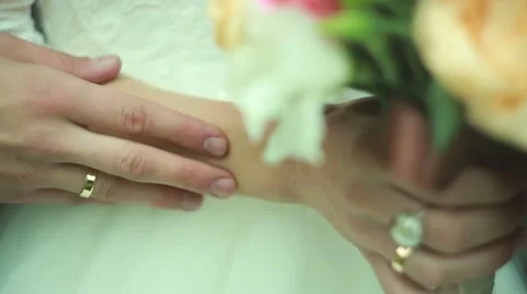 The groom hand stroking the bride, wedding rings, flowers, Ukraine Stock Footage 55580387
