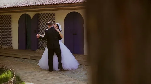 Groom holding bride in dance pose on wedding day Stock Footage 48924350