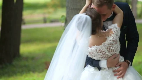 Groom holding bride in dance pose on wedding day Stock Footage 85610360