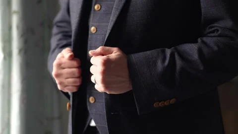 Groom holding his jacket with both hands Stock Footage 278047542