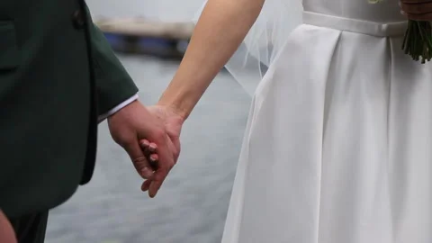 The groom holds the bride's hand Vídeos de archivo 255043889