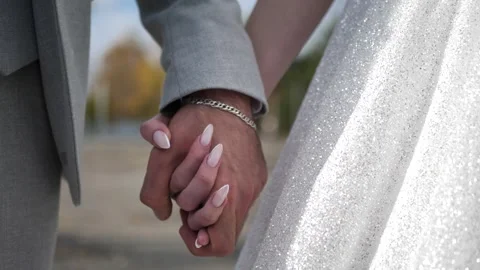 The groom holds the bride's hand. Hands close up Stock Footage 260970830