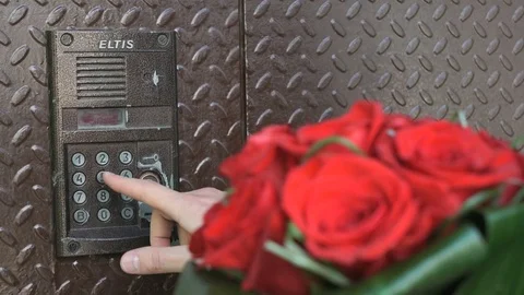 Groom holds in one hand a bouquet of red roses Stock Footage