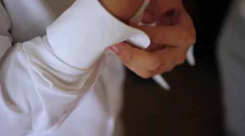 Groom Inserting Cuff Links Video stock 64143674