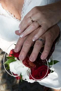 The groom inserting a diamond ring into the bride's finger Stock Photos