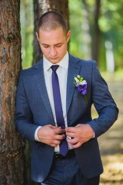Groom jacket fastens Stock Photos