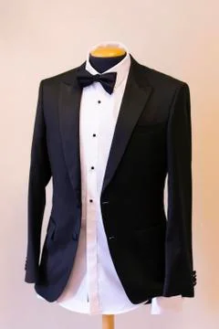 The groom jacket hangs in the test doll Stock Photos