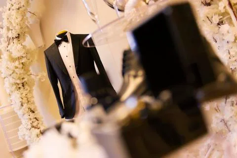 The groom jacket hangs in the test doll Stock Photos