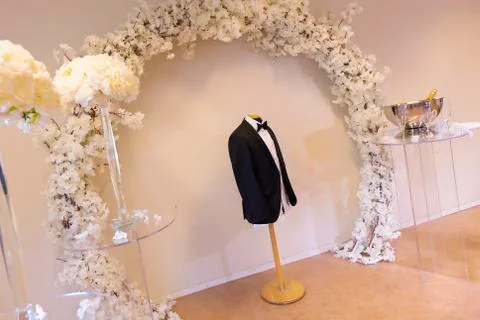 The groom jacket hangs in the test doll Stock Photos