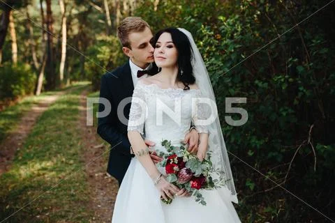 Groom kisses the bride Stock Photos