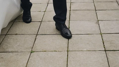 The groom leads the bride on a walk along the cobblestones Stock Footage 246745782