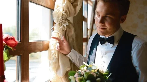 Groom look at the window Stock Footage 70401038