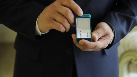 Groom opens blue box with wedding rings Stock Footage 171639035