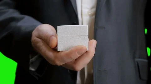 The groom opens the box with a wedding ring. Green screen. Stock Footage 73128254