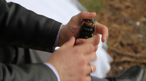 Groom opens the champagne Stock Footage 61693004