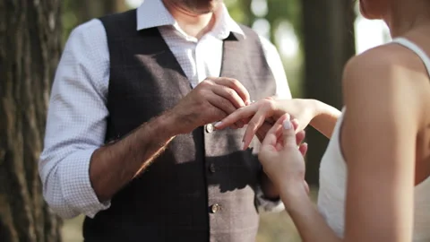 Groom Placing Wedding Ring on Bride Finger Stock Footage 312143836