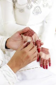 A groom put on a ring to the bride Stock Photos