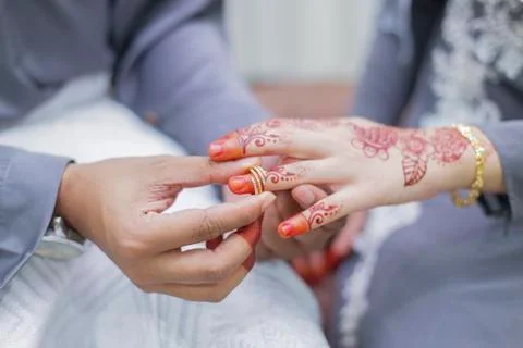 Groom put a wedding ring on bride hand Stock Photos