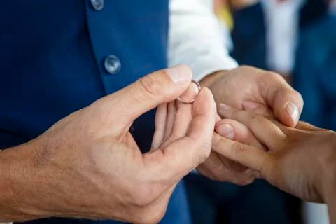 Groom Put the Wedding Ring on bride. Close up Stock Photos