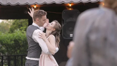 The groom puts the bride on his hand in a romantic dance Stock Footage 127933352
