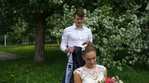 The groom puts the bride his jacket Stock Footage