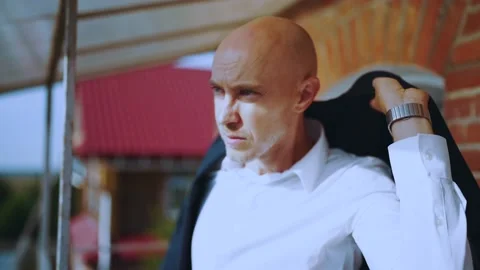 The groom puts on a jacket on the balcony Stock Footage 200941507