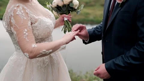  groom puts the ring on the bride Stock Footage 149345223