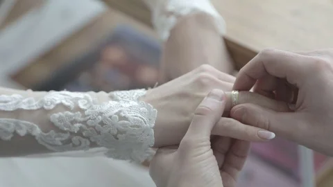 Groom puts ring on bride’s finger Stock Footage 72383793