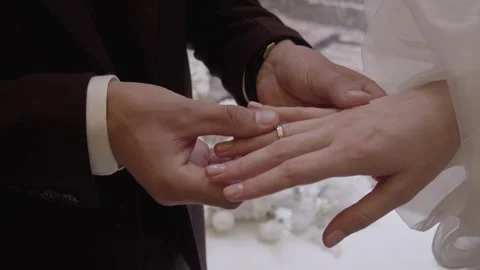 The groom puts a ring on the bride's finger at the wedding ceremony. Stock Footage 257618905