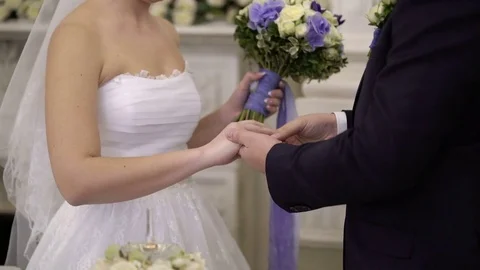 Groom puts on ring to bride's hand on ceremony Stock Footage 72781612